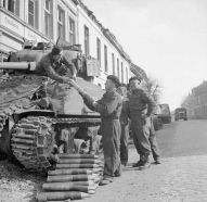 Tripulantes de un tanque Sherman de la 8.ª Brigada Blindada Británica cargando munición M61 cerca de Xanten, Alemania, 21 de marzo de 1945.