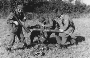 Tres Fallschirmjäger, paracaidistas alemanes, comprobando su cañón sin retroceso LG 40 antes de entrar en acción.