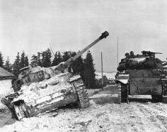 Un cazacarros estadounidense M10 GMC pasando al lado de un Pz.IV Ausf. J inmovilizado durante los combates en las Ardenas.